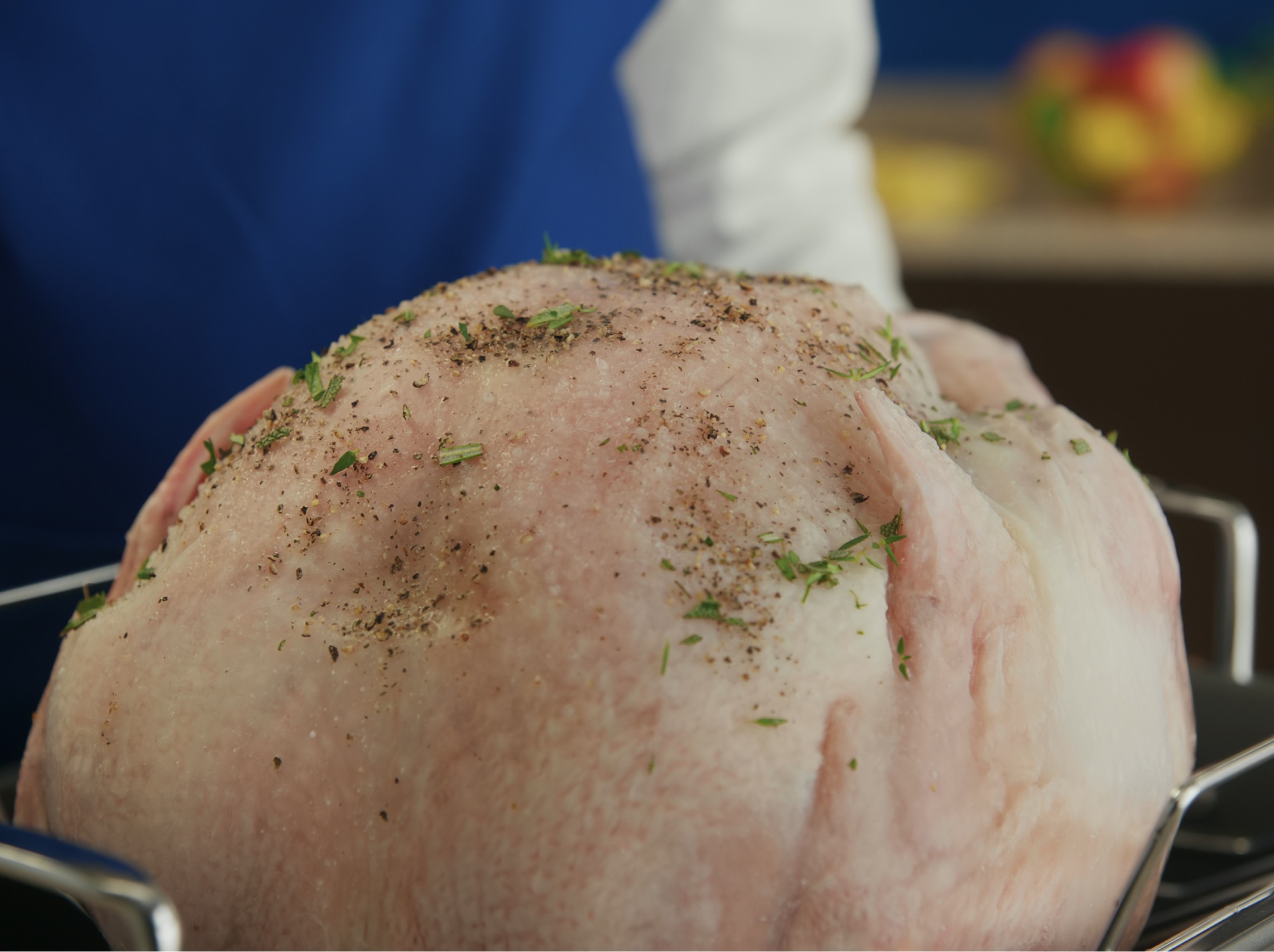 An uncooked turkey with seasonings