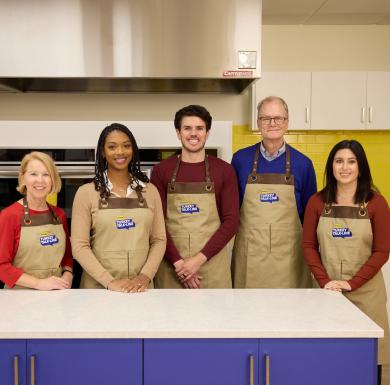 A group of Butterball Turkey Talk Line turkey experts pose in a kitchen.