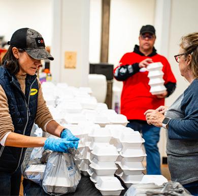 : Butterball team members package meals for Butterball’s Our shared table philanthropic campaign.