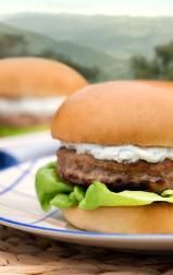 Butterball turkey burger with creamy sauce and lettuce, served on a bun for a fresh summer meal.
