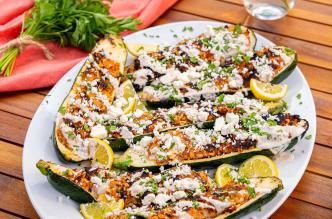 A platter of grilled ground turkey-stuffed zucchini boats.