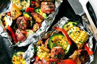 Grilled veggies and turkey sausage in foil packs with corn, zucchini, peppers, and potatoes.