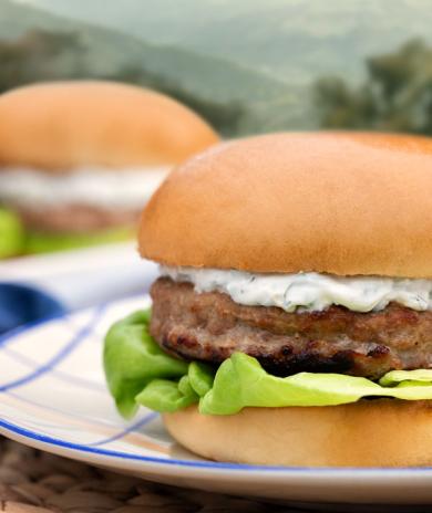 Butterball turkey burger with creamy sauce and lettuce, served on a bun for a fresh summer meal.