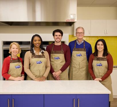 A group of Butterball Turkey Talk Line turkey experts pose in a kitchen.