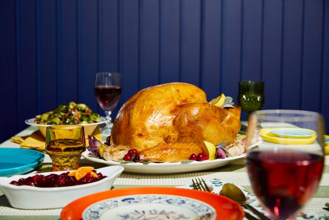 Turkey on a plate as part of a dinner spread.