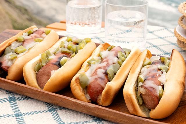 Image of Philly Cheesesteak Grilled Sausages on a tray by the beach.