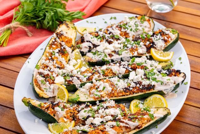 A platter of grilled ground turkey-stuffed zucchini boats.