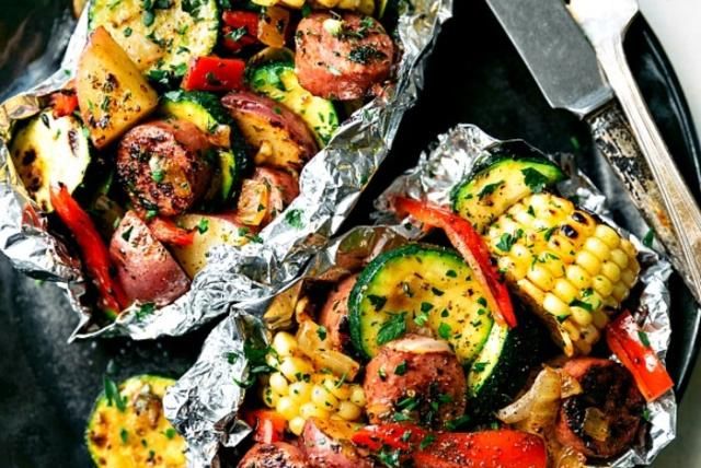 Grilled veggies and turkey sausage in foil packs with corn, zucchini, peppers, and potatoes.
